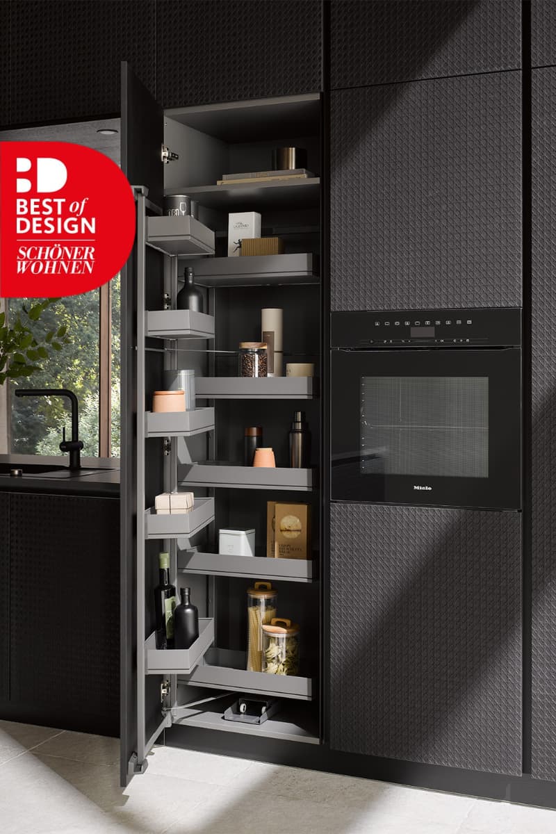 Colonne de rangement intelligent avec tiroirs coulissants intégrés dans une cuisine sur mesure noire design, primée Best of Design